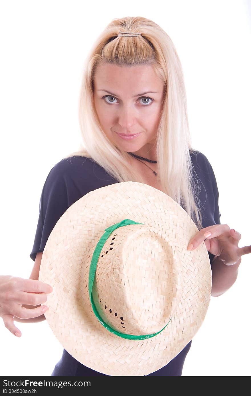 Beautiful young blond woman holding a straw hat