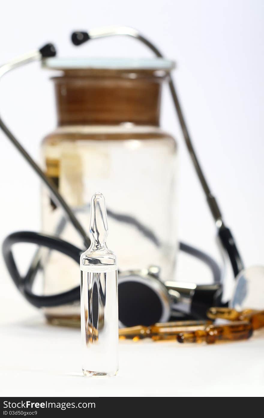 Ampoules of drugs on a white background and medical supplies