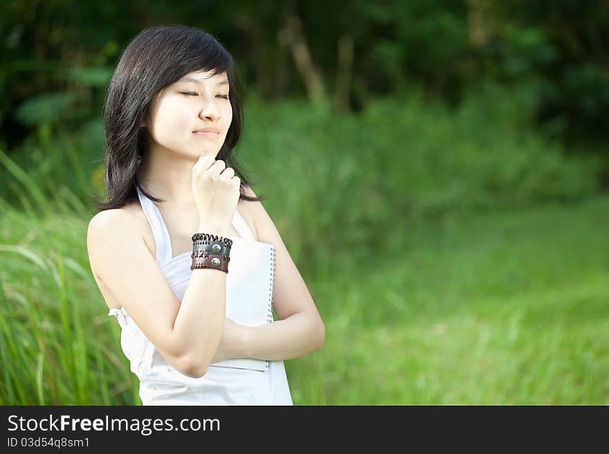 Portrait of a Beautiful Asian Chinese/Japanese girl laughing outdoors. Portrait of a Beautiful Asian Chinese/Japanese girl laughing outdoors