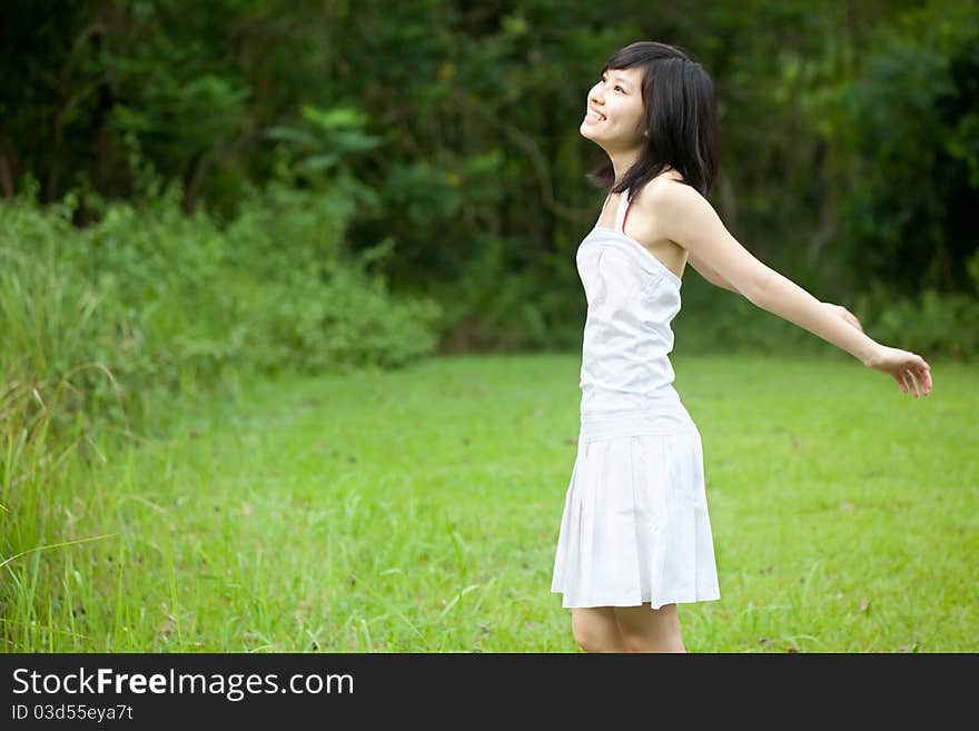 Beautiful Asian girl laughing outdoors