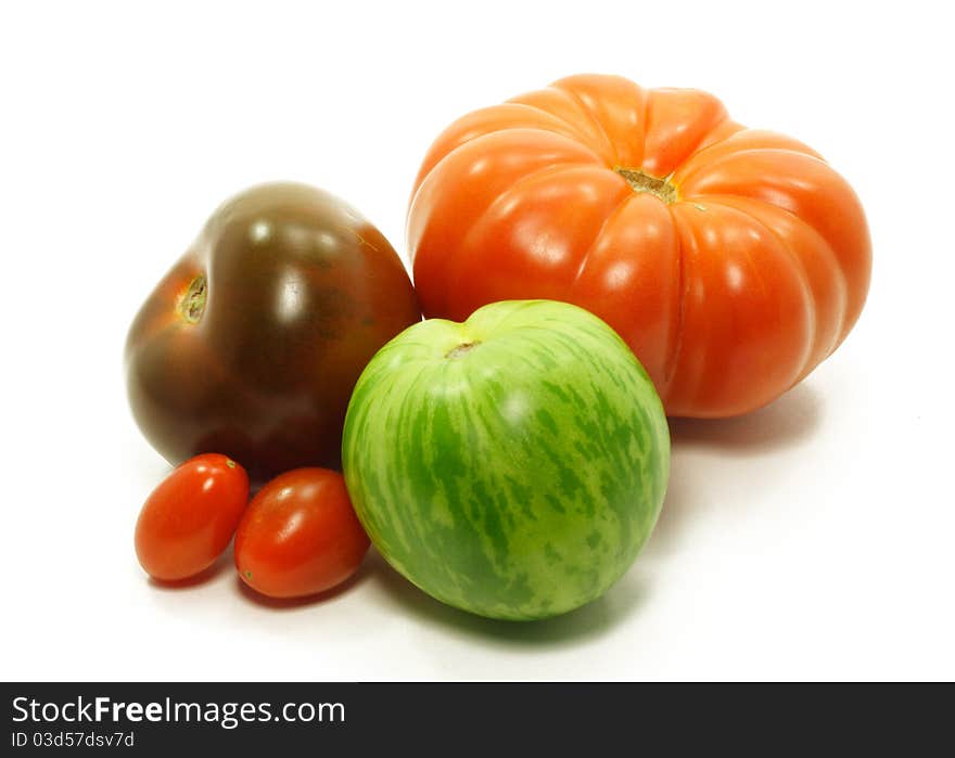 Variety of unusual tomatoes isolated on white. Variety of unusual tomatoes isolated on white.