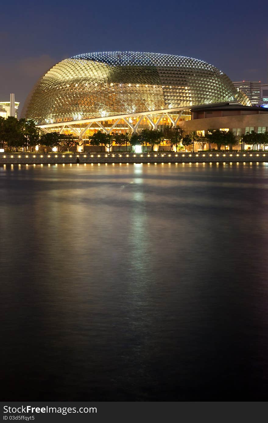 The Esplanade, affectionately known as the durian by locals due to the shape of the roof, is a concert and theatre in Singapore. With copyspace in reflection of lights in water. The Esplanade, affectionately known as the durian by locals due to the shape of the roof, is a concert and theatre in Singapore. With copyspace in reflection of lights in water.