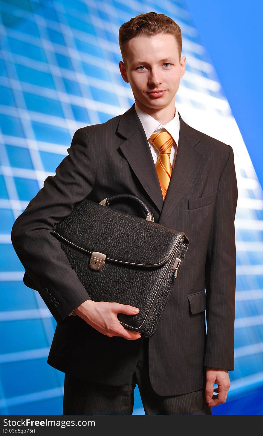 Portrait of a successful young business man carrying a suitcase