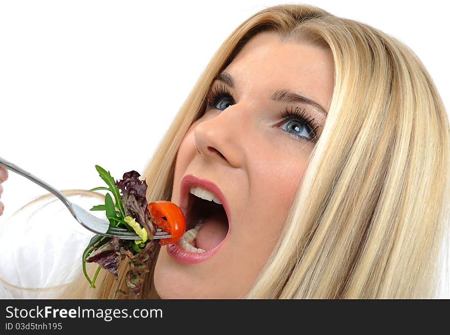 Pretty woman eating green vegetable salad. isolated on white