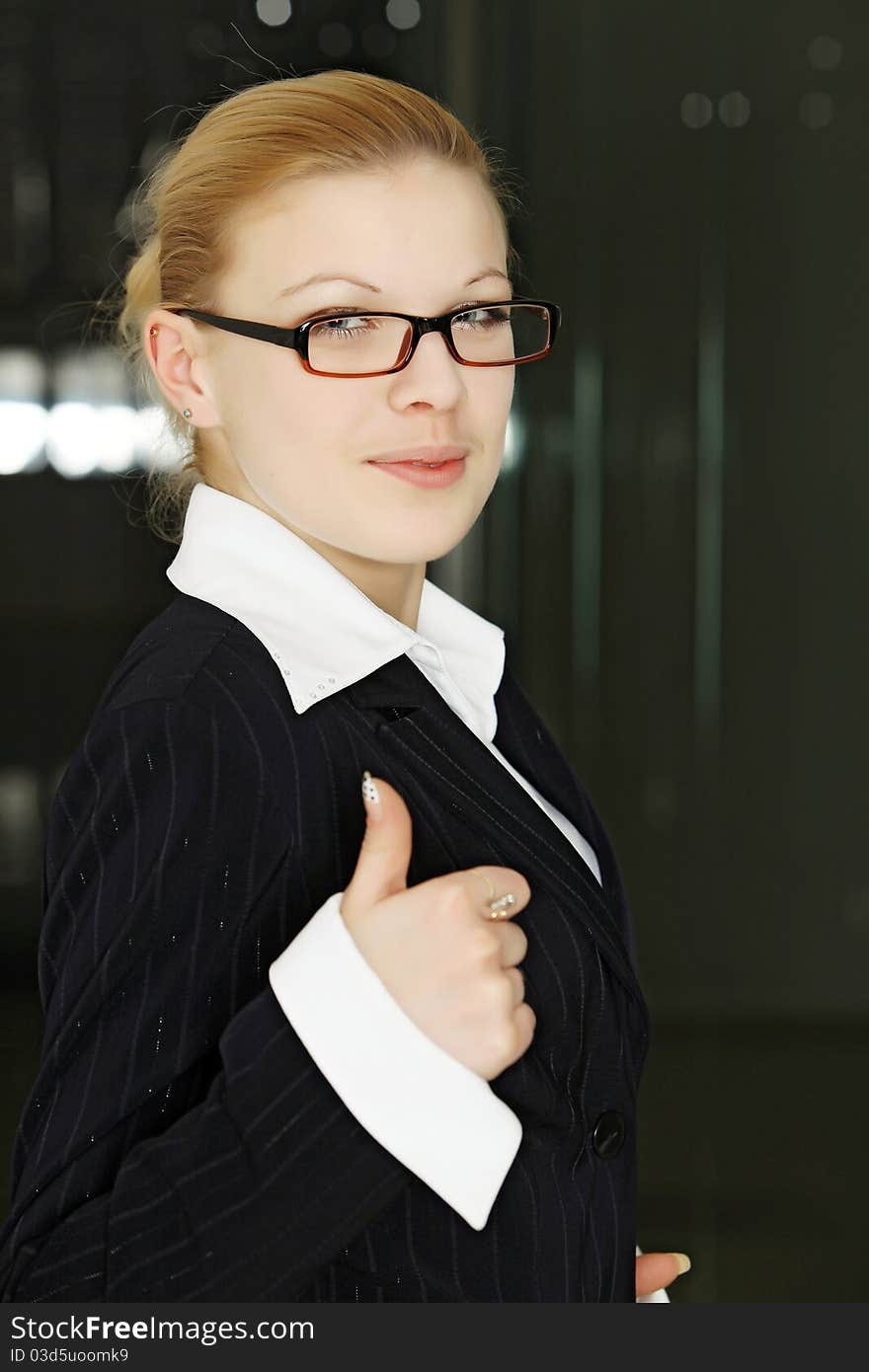 Thumbs up. Smiling young female