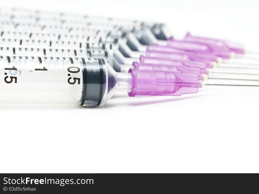 Closeup, Isolated disposable syringes in the row on white background