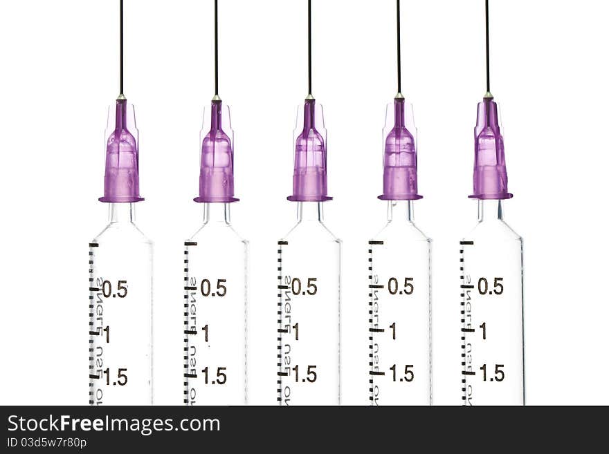 Closeup, Isolated five disposable syringe in the row on white background