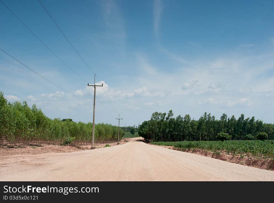 A dirt dusty road across ranches in rural Thailand. A dirt dusty road across ranches in rural Thailand