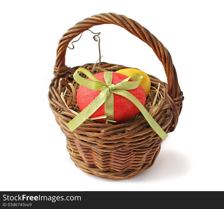 Red Easter egg in a basket on a white background