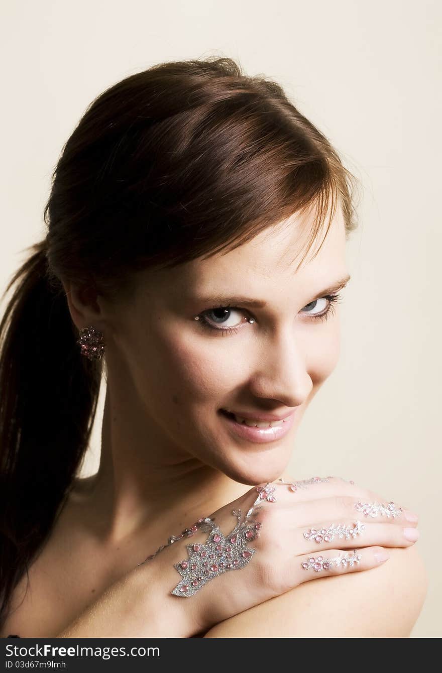 Young woman portrait with rhinestones on hands