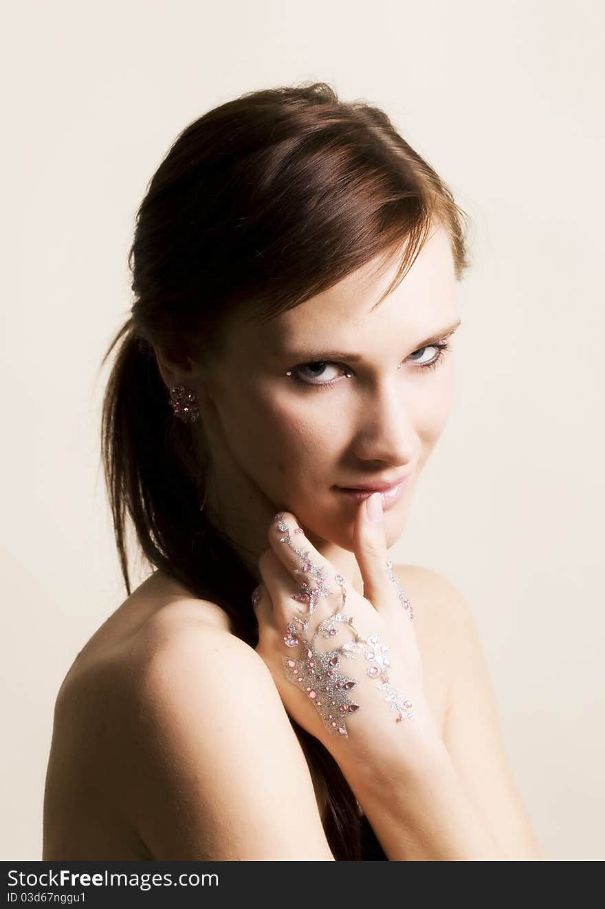 Young woman portrait with rhinestones on hands