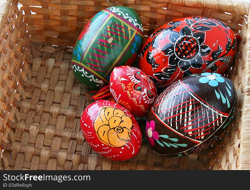 Colored easter eggs in a woven basket