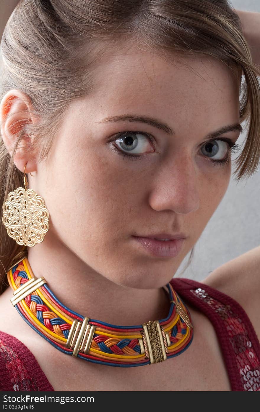 A close up portrait of a beautiful girl wearing exotic jewelry. A close up portrait of a beautiful girl wearing exotic jewelry