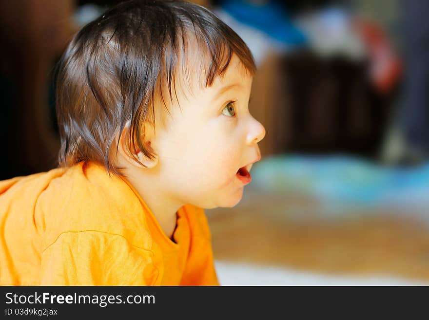 Funny baby looking at something in the room