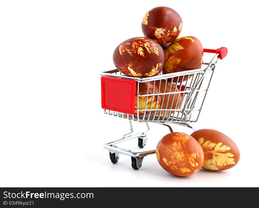 Easter eggs in shopping trolley isolated on white background. Easter eggs in shopping trolley isolated on white background