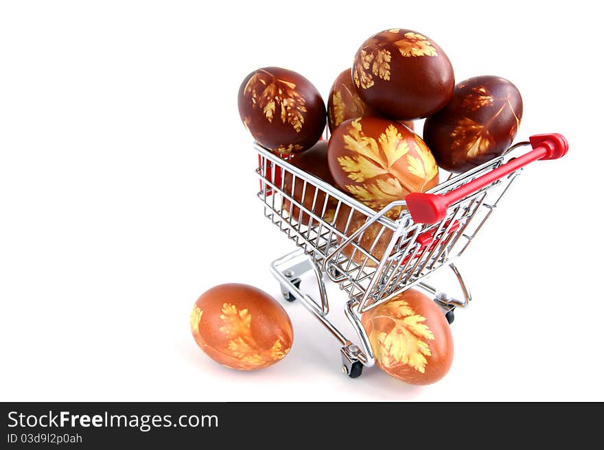 Easter eggs in shopping trolley isolated on white background. Easter eggs in shopping trolley isolated on white background