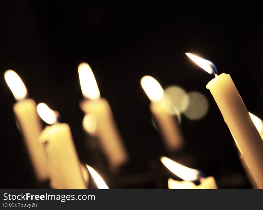 Light candles in the inside of a dark church.