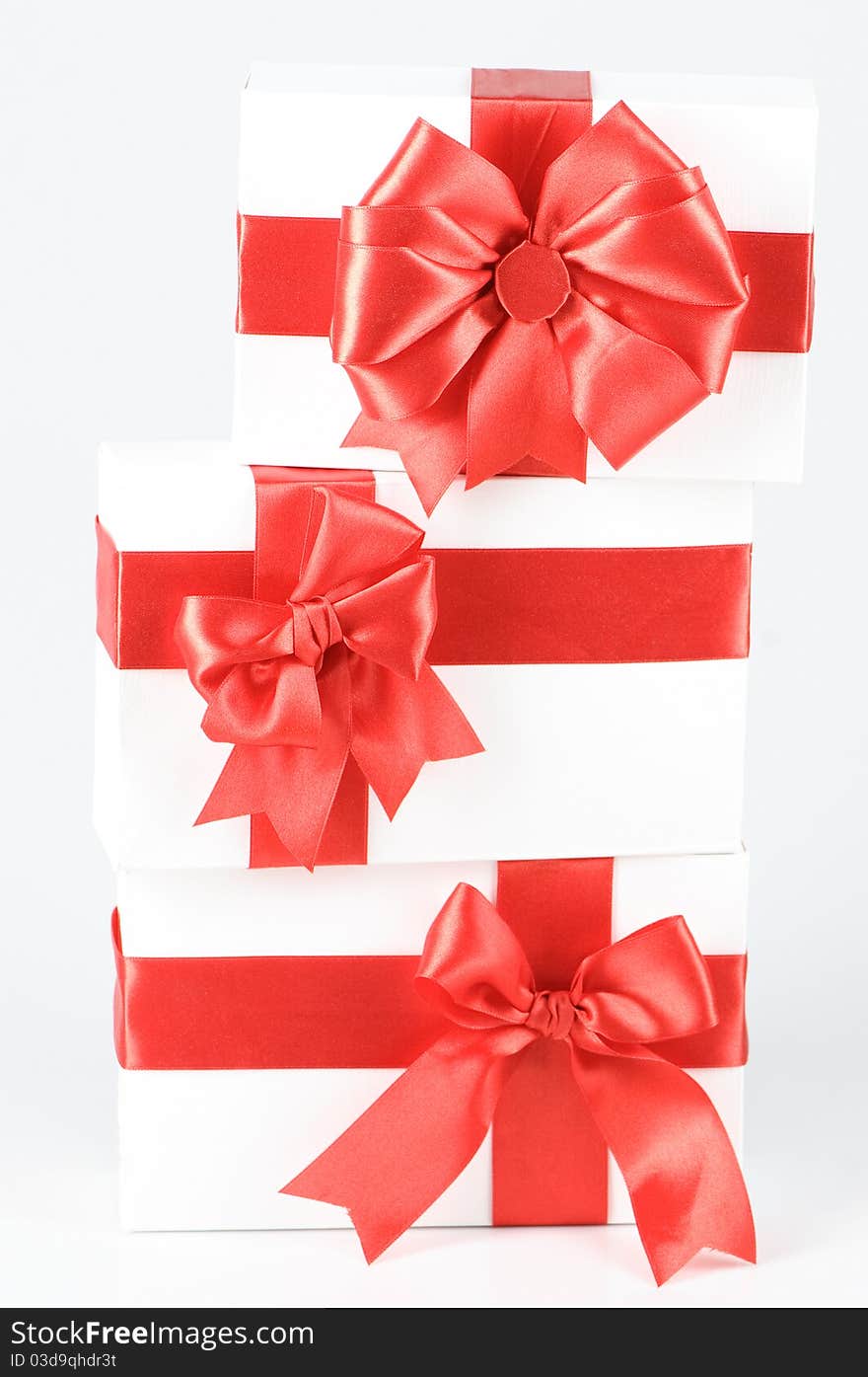 Boxes with red ribbons on white. Boxes with red ribbons on white