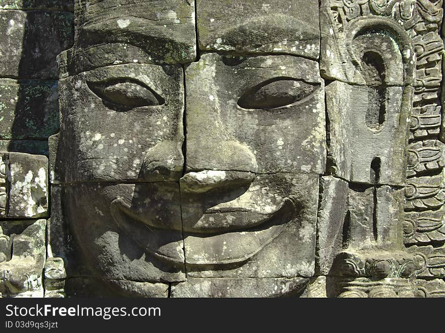 On the photo:Stone head on towers of Bayon temple in Angkor Thom, Cambodia