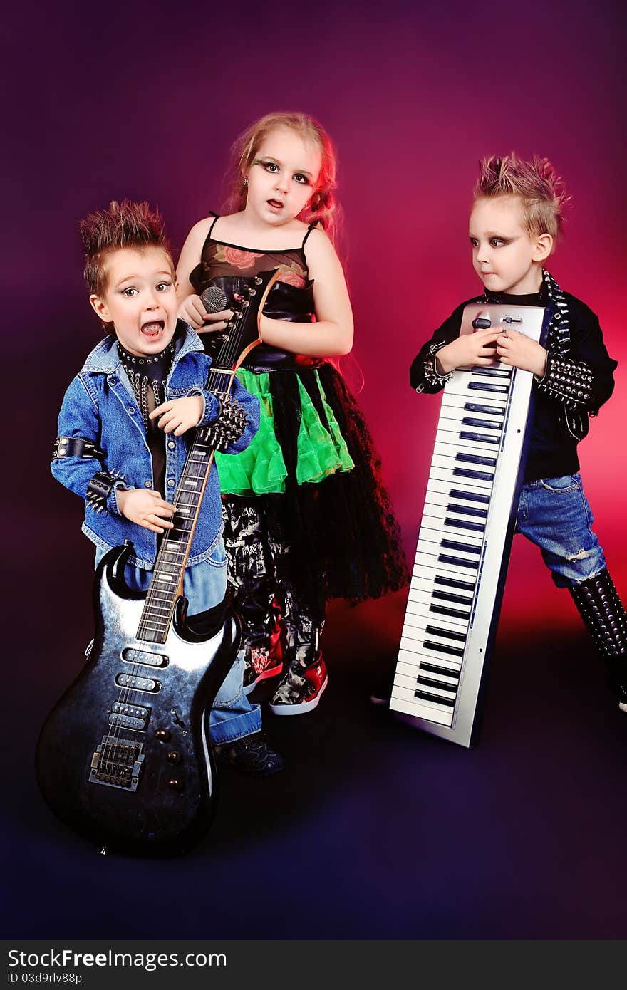 Group of children singing in heavy metal style. Shot in a studio. Group of children singing in heavy metal style. Shot in a studio.