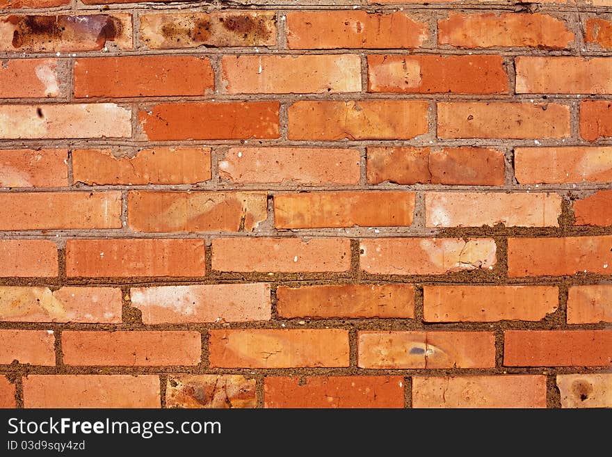 Weathered stained old brick wall background. Weathered stained old brick wall background