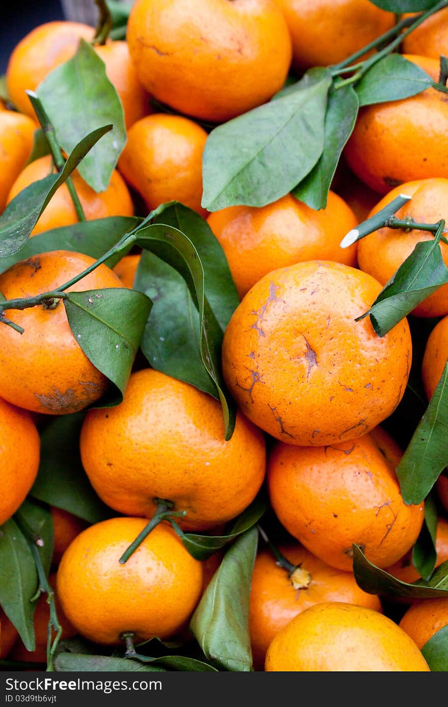 Fresh Picked Tangerines on stems for sale in market in Bali.