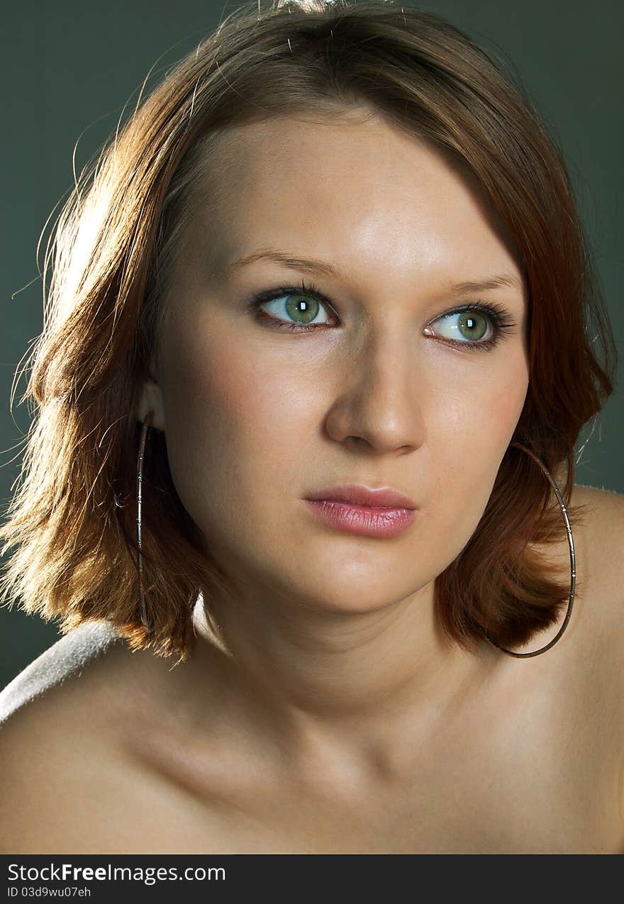 Portrait of the beautiful girl on a dark background