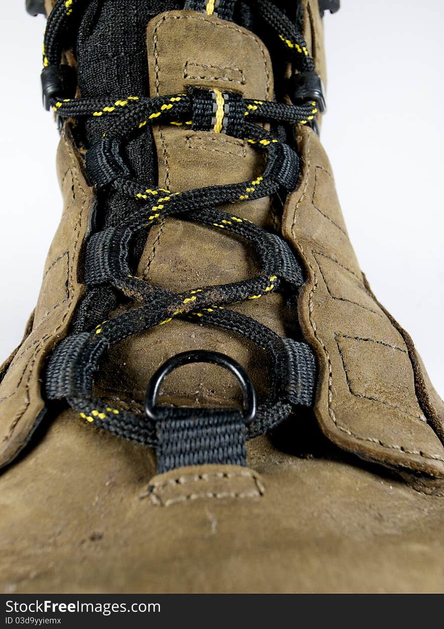 A close of a single hiking boot on a white background. A close of a single hiking boot on a white background