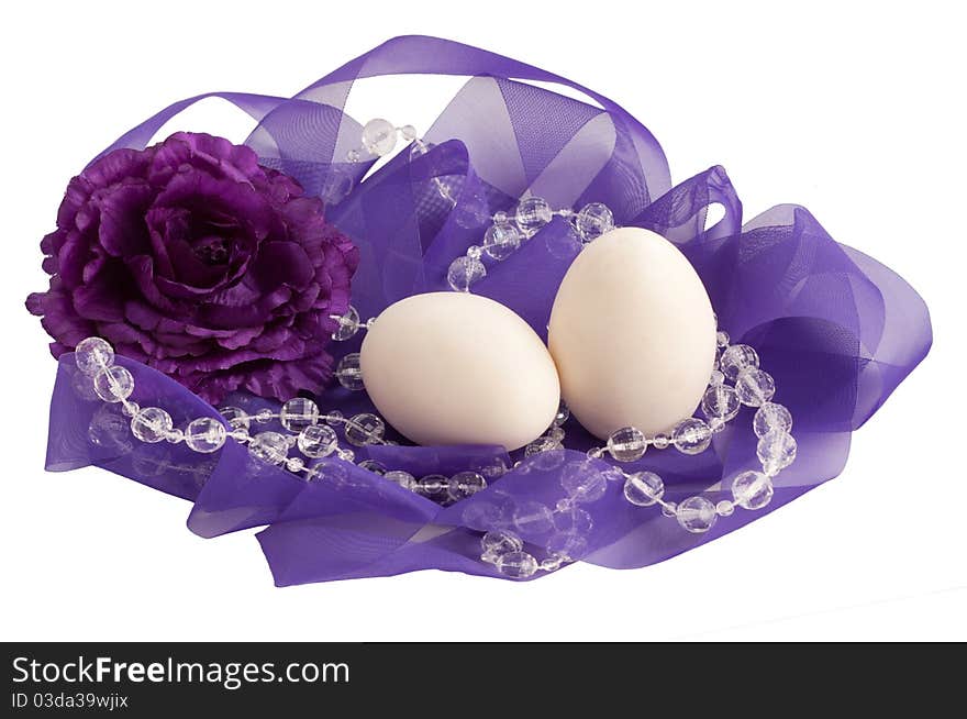 Two eggs and flower in a lovely purple ribbon nest. Two eggs and flower in a lovely purple ribbon nest