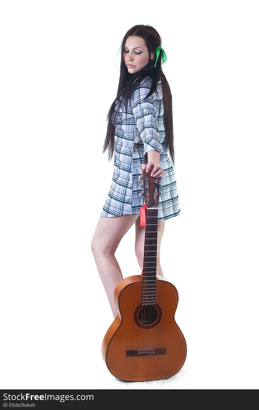 The girl with a guitar with a shirt and long black hair on a white background