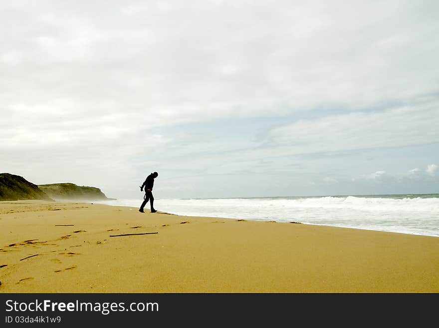 Man walking towards the waves. Man walking towards the waves