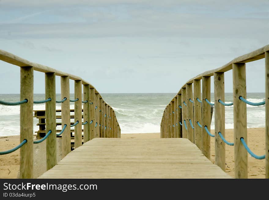 Wood access to empty beach in stormy day. Wood access to empty beach in stormy day