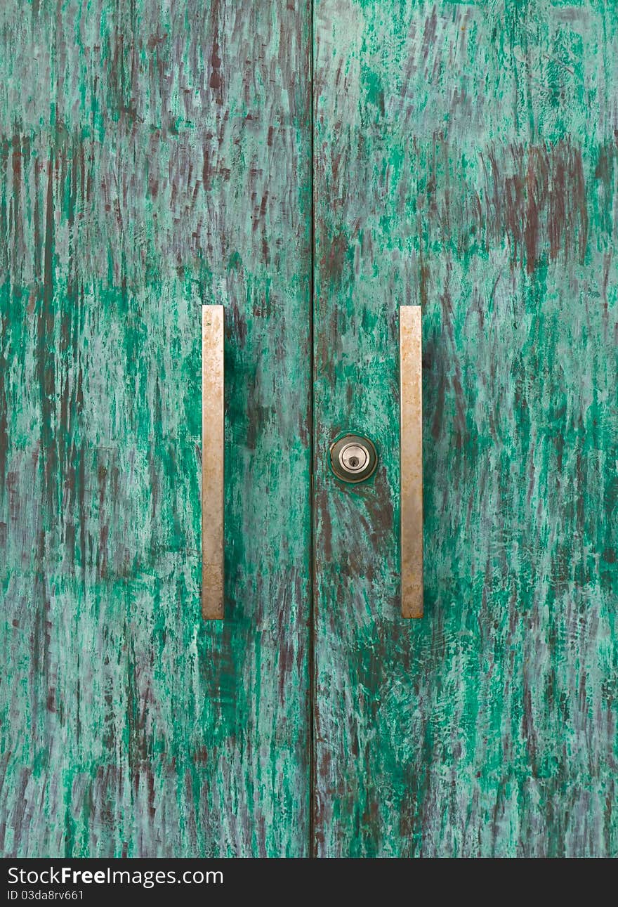 Wood green door with knob and keyhole