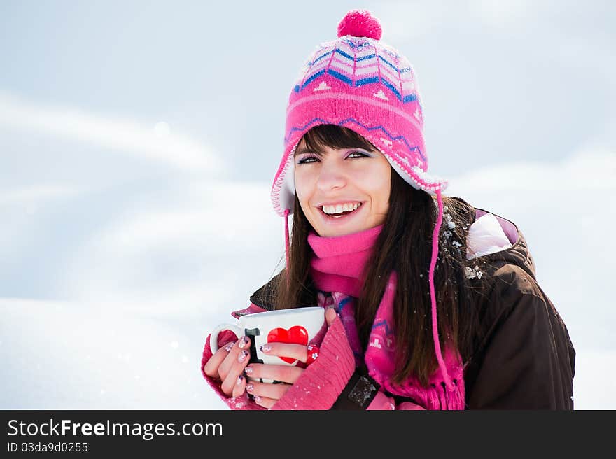 Smiling winter lady with the cup of tea on snow background. Smiling winter lady with the cup of tea on snow background