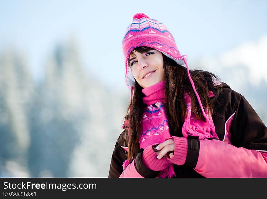 Attractive winter woman on sky and mountains background. Attractive winter woman on sky and mountains background