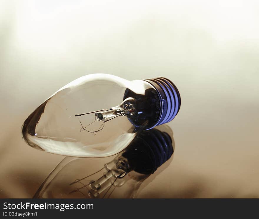 Incandescence bulb on a light brown background. Incandescence bulb on a light brown background