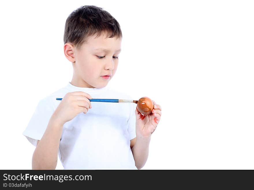 Boy painting easter egg