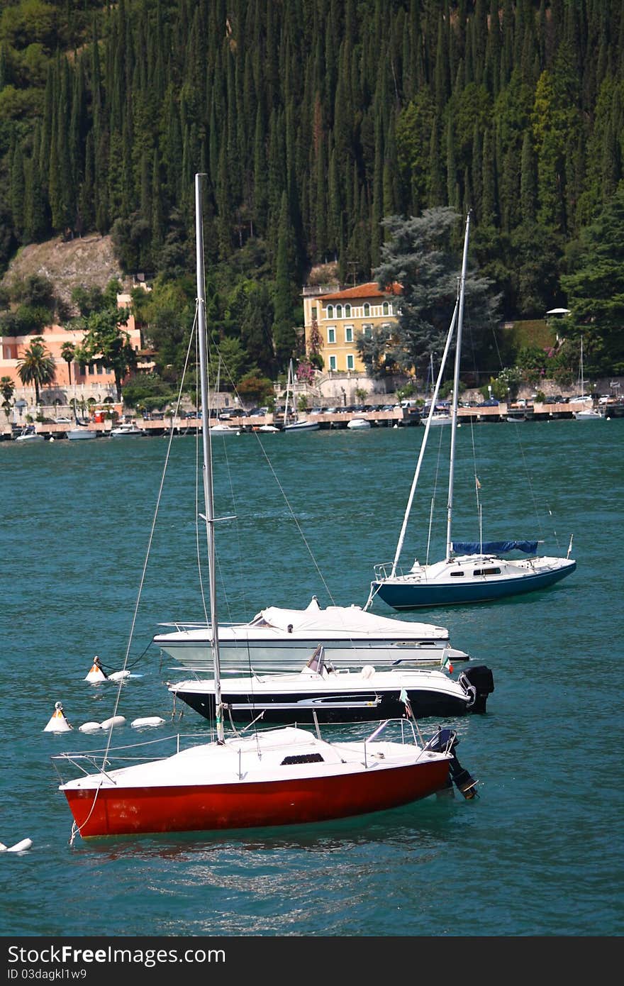 three boats moored at the lake in the summer ready to go. three boats moored at the lake in the summer ready to go