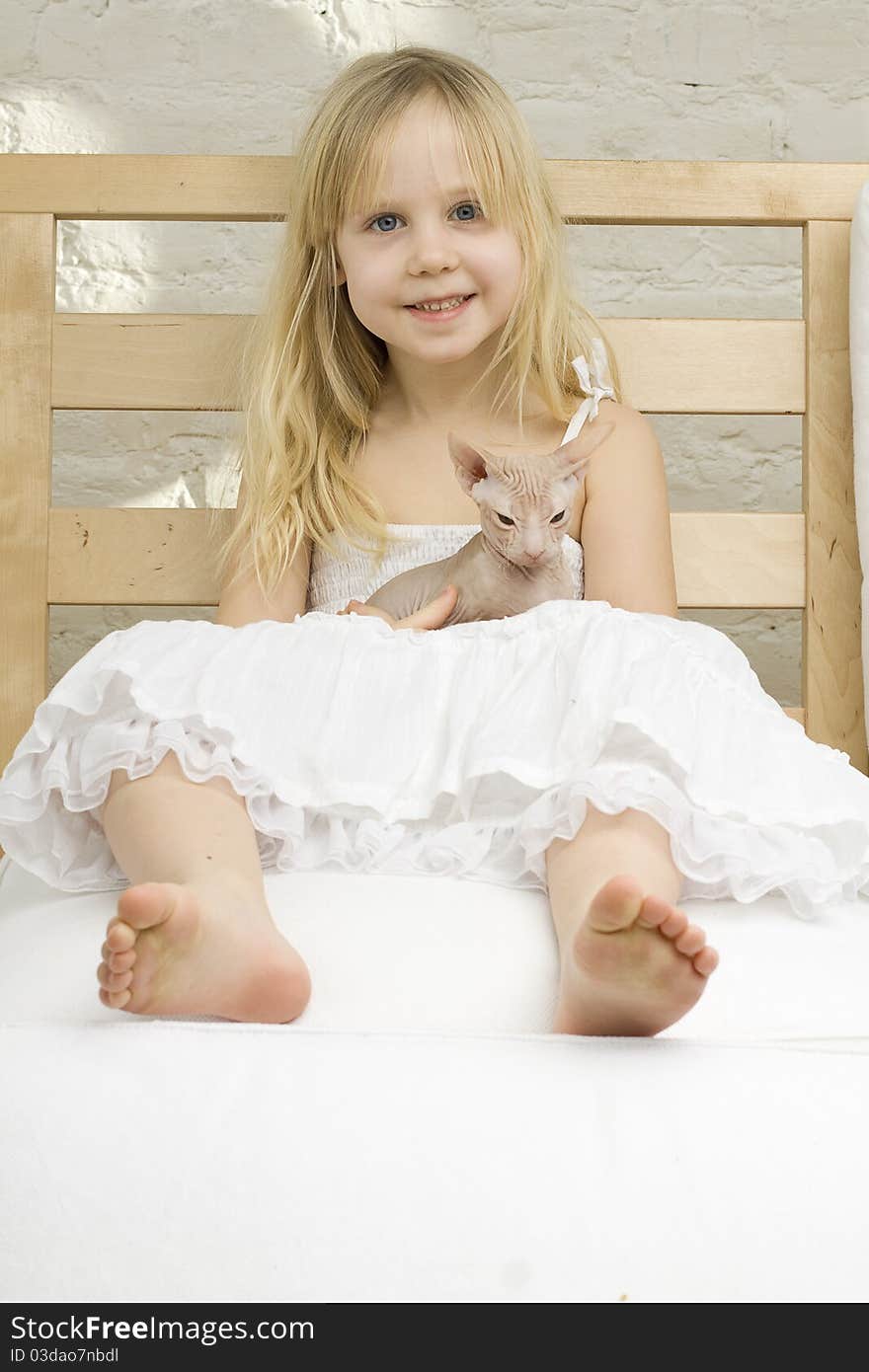 Joyful little girl with kitten