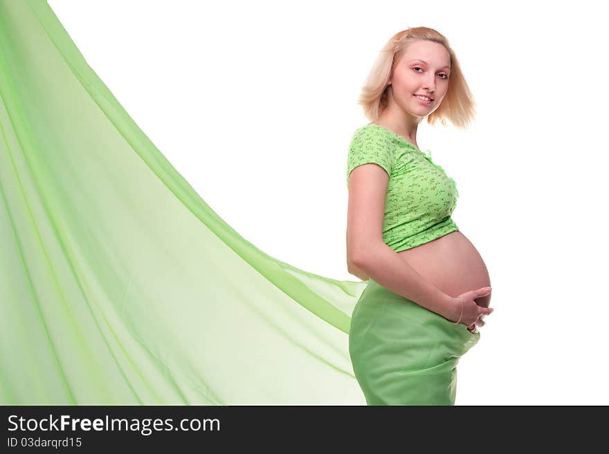 Beautiful young pregnant blonde woman with green transparent cloth in studio. Beautiful young pregnant blonde woman with green transparent cloth in studio