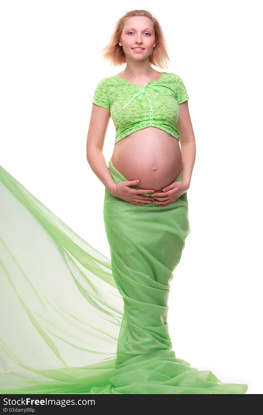 Beautiful young pregnant blonde woman with green transparent cloth in studio. Beautiful young pregnant blonde woman with green transparent cloth in studio