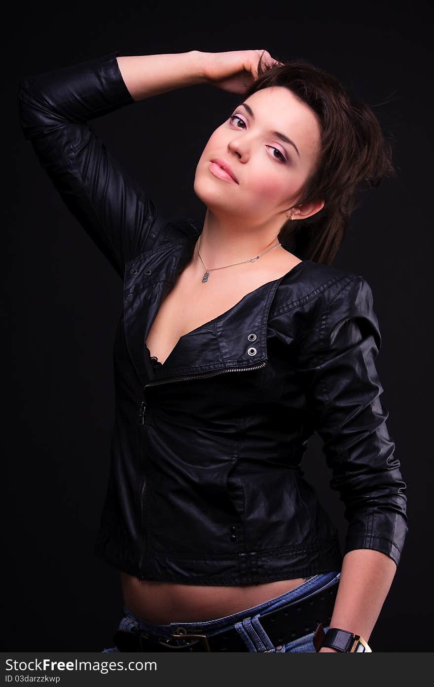 Attractive girl in a black coat posing