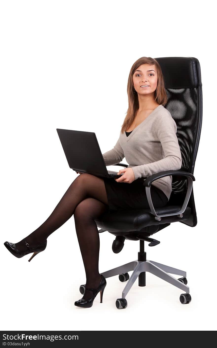 Young business lady in a chair with a laptop isolated on white background