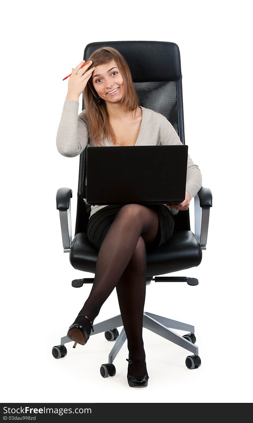 Young business lady in a chair with a laptop