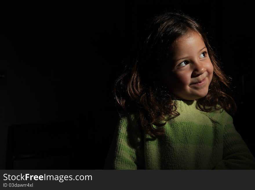 Pretty young girl ingreen jumper looking up to light. Pretty young girl ingreen jumper looking up to light