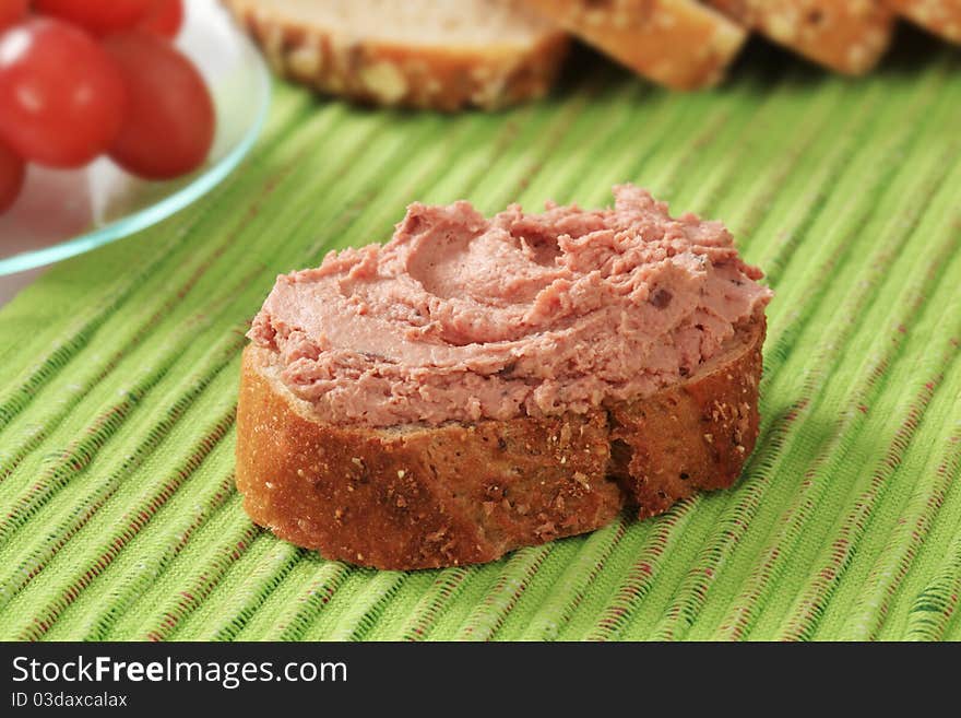 Slice of bread roll and liver pate. Slice of bread roll and liver pate