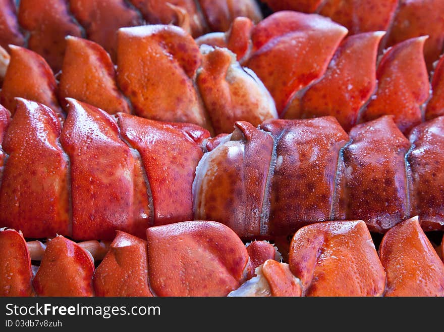 A selection of cooked lobster tails packed like sardines