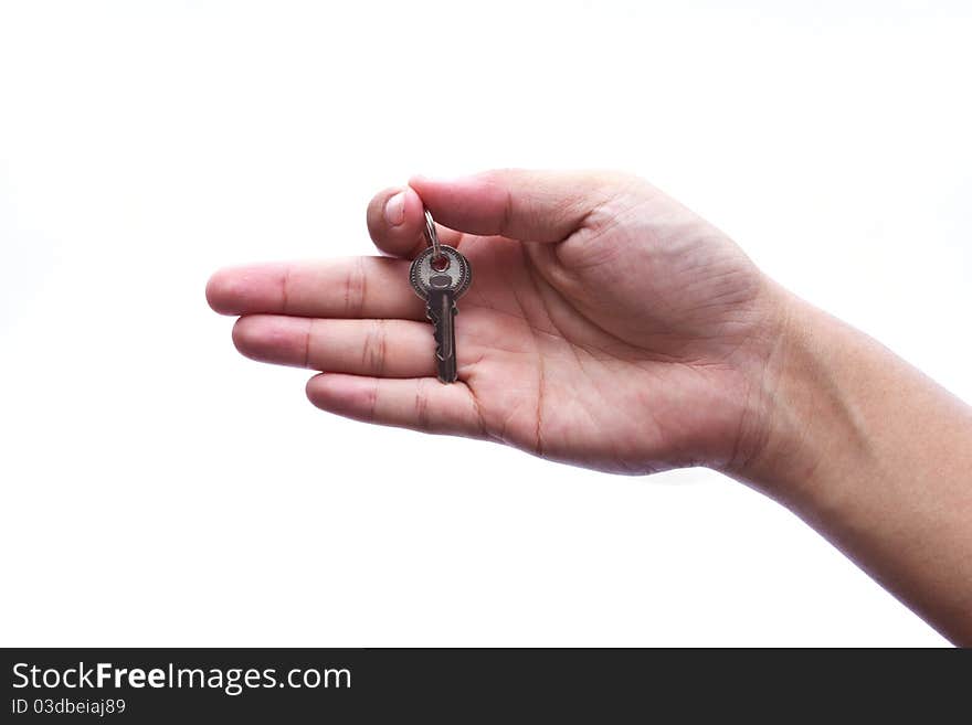 Silver key in a hand isolated on white.