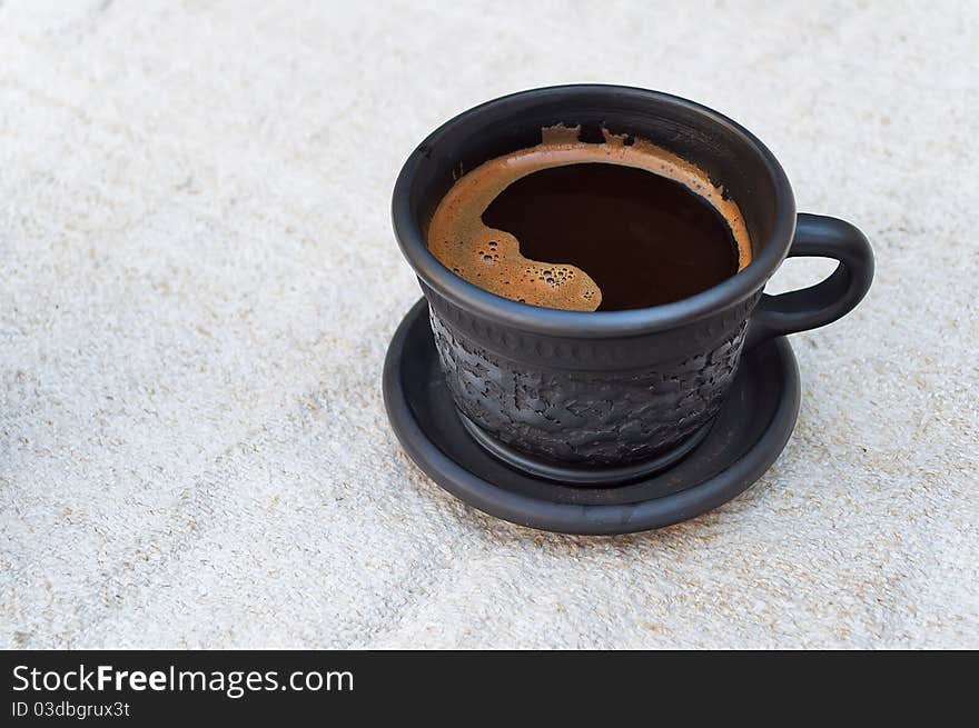 A cup of coffee on a linen tablecloth