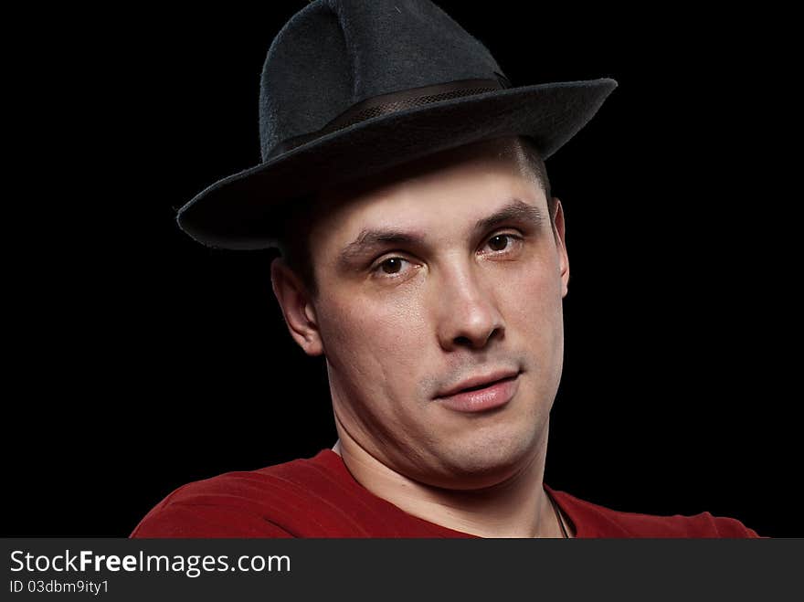 Man in a grey hat. Isolated on black background